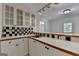 The wet bar includes white cabinets and a stainless steel sink at 5245 Cottage Farm Rd, Johns Creek, GA 30022