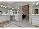 Bright bathroom featuring dual vanities, a soaking tub, and an open doorway to the bedroom at 5245 Cottage Farm Rd, Johns Creek, GA 30022