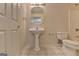 This bathroom has a pedestal sink, toilet and large mirror at 5245 Cottage Farm Rd, Johns Creek, GA 30022