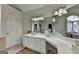 Bright bathroom features double mirrors, a makeup counter, and a soaking tub at 5245 Cottage Farm Rd, Johns Creek, GA 30022