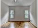 Spacious bedroom with two bright windows and hardwood floors throughout at 5245 Cottage Farm Rd, Johns Creek, GA 30022