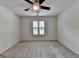 Bedroom with soft carpet, neutral paint, a ceiling fan, and bright windows at 5245 Cottage Farm Rd, Johns Creek, GA 30022