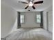 Bedroom featuring carpet, windows with curtains, and a ceiling fan at 5245 Cottage Farm Rd, Johns Creek, GA 30022