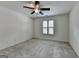 Cozy bedroom featuring neutral walls, soft carpet, bright windows, and a stylish ceiling fan at 5245 Cottage Farm Rd, Johns Creek, GA 30022