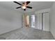 Bedroom with neutral walls, soft carpet, bright windows, ceiling fan, and closet at 5245 Cottage Farm Rd, Johns Creek, GA 30022
