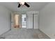 Bedroom with neutral walls, soft carpet, bright windows, ceiling fan, and closet at 5245 Cottage Farm Rd, Johns Creek, GA 30022