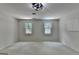 The bedroom has neutral carpet and two large windows at 5245 Cottage Farm Rd, Johns Creek, GA 30022