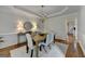 Dining room features modern lighting, neutral colors, and crown molding at 5245 Cottage Farm Rd, Johns Creek, GA 30022