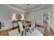 Bright dining room features a wooden table, chandelier lighting and decorative wainscoting at 5245 Cottage Farm Rd, Johns Creek, GA 30022