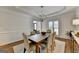 Elegant dining room with chandelier, beautiful wainscoting and hardwood floors at 5245 Cottage Farm Rd, Johns Creek, GA 30022