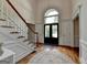 Bright foyer with hardwood floors, staircase, and classic trim at 5245 Cottage Farm Rd, Johns Creek, GA 30022