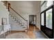 Bright foyer with hardwood floors, staircase, and classic trim at 5245 Cottage Farm Rd, Johns Creek, GA 30022