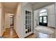 Light-filled foyer with hardwood floors, white trim, and decorative glass door leads to living spaces at 5245 Cottage Farm Rd, Johns Creek, GA 30022