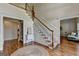 Bright foyer with hardwood floors, staircase, and classic trim at 5245 Cottage Farm Rd, Johns Creek, GA 30022