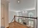 Hallway view overlooking the living room and grand windows at 5245 Cottage Farm Rd, Johns Creek, GA 30022
