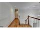 Bright hallway features hardwood floors, crown molding, and access to upper and lower levels at 5245 Cottage Farm Rd, Johns Creek, GA 30022
