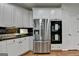 Modern kitchen featuring stainless steel appliances, double ovens, granite counters and white cabinets at 5245 Cottage Farm Rd, Johns Creek, GA 30022