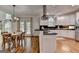 Bright kitchen featuring white cabinets, stainless steel appliances, a black countertop island, and wood floors at 5245 Cottage Farm Rd, Johns Creek, GA 30022