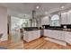 Open kitchen with stainless steel appliances, an island cooktop, and hardwood floors at 5245 Cottage Farm Rd, Johns Creek, GA 30022