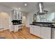 Bright, updated kitchen boasting stainless hood, glass cabinet display, and smooth hardwood floors at 5245 Cottage Farm Rd, Johns Creek, GA 30022