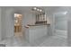 Kitchenette features white cabinets, a checkered backsplash, and a tiled floor at 5245 Cottage Farm Rd, Johns Creek, GA 30022