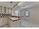 Kitchenette features white cabinets, a checkered backsplash, and a tiled floor at 5245 Cottage Farm Rd, Johns Creek, GA 30022