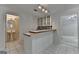 Kitchenette features white cabinets, a checkered backsplash, and a tiled floor at 5245 Cottage Farm Rd, Johns Creek, GA 30022