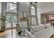 Bright living room features a fireplace, large windows, and hardwood floors at 5245 Cottage Farm Rd, Johns Creek, GA 30022