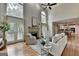 Bright living room features a fireplace, large windows, and an open layout connecting to the kitchen at 5245 Cottage Farm Rd, Johns Creek, GA 30022