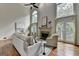 Grand living room with soaring ceilings, fireplace, and large windows providing abundant natural light at 5245 Cottage Farm Rd, Johns Creek, GA 30022