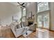 Grand living room with soaring ceilings, fireplace, and large windows providing abundant natural light at 5245 Cottage Farm Rd, Johns Creek, GA 30022