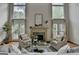 Elegant living room showcasing a cozy fireplace and expansive windows providing bright natural light at 5245 Cottage Farm Rd, Johns Creek, GA 30022