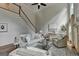 Cozy living room featuring a fireplace, staircase, and ample seating for relaxing and entertaining at 5245 Cottage Farm Rd, Johns Creek, GA 30022