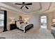 Bright main bedroom with neutral colors, ceiling fan, tray ceiling, and ensuite bathroom access at 5245 Cottage Farm Rd, Johns Creek, GA 30022