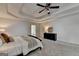 Bright main bedroom with neutral color, ceiling fan, tray ceiling and ensuite bathroom access at 5245 Cottage Farm Rd, Johns Creek, GA 30022