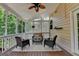 Inviting screened porch with wicker furniture, ceiling fan and wooded view at 5245 Cottage Farm Rd, Johns Creek, GA 30022