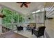 Inviting screened porch with wicker furniture, ceiling fan and wooded view at 5245 Cottage Farm Rd, Johns Creek, GA 30022