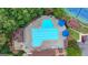 Aerial view of a large community pool with blue umbrellas and lounge chairs, perfect for relaxation and recreation at 5245 Cottage Farm Rd, Johns Creek, GA 30022