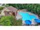 Aerial view of community pool, clubhouse, and lounge area surrounded by trees at 5245 Cottage Farm Rd, Johns Creek, GA 30022