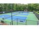 Aerial view of community tennis courts surrounded by lush trees at 5245 Cottage Farm Rd, Johns Creek, GA 30022