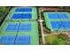 Aerial view of community tennis courts surrounded by lush trees and landscaping at 5245 Cottage Farm Rd, Johns Creek, GA 30022