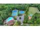Aerial view of tennis courts and playground nestled in a lush, green, wooded area near the community pool at 5245 Cottage Farm Rd, Johns Creek, GA 30022