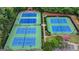 Aerial view of community tennis courts surrounded by lush trees and landscaping at 5245 Cottage Farm Rd, Johns Creek, GA 30022