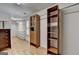 Walk-in closet with custom shelving, hanging rods, and wood flooring at 5245 Cottage Farm Rd, Johns Creek, GA 30022