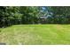 Lush green backyard with mature trees, offering privacy at 9230 Melody Sw Cir, Covington, GA 30014