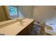 Bathroom with a bathtub, sink, and toilet offering essential amenities at 9230 Melody Sw Cir, Covington, GA 30014