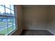 Bedroom featuring neutral carpet, beige walls and a large window with a view of the neighborhood at 9230 Melody Sw Cir, Covington, GA 30014