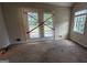 Spacious bedroom featuring a window and glass doors leading to the outdoors at 9230 Melody Sw Cir, Covington, GA 30014