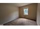 This bedroom features a window and carpeted floors at 9230 Melody Sw Cir, Covington, GA 30014