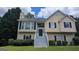 Charming two-story home with a welcoming entrance, crisp white trim, and professionally landscaped yard at 9230 Melody Sw Cir, Covington, GA 30014